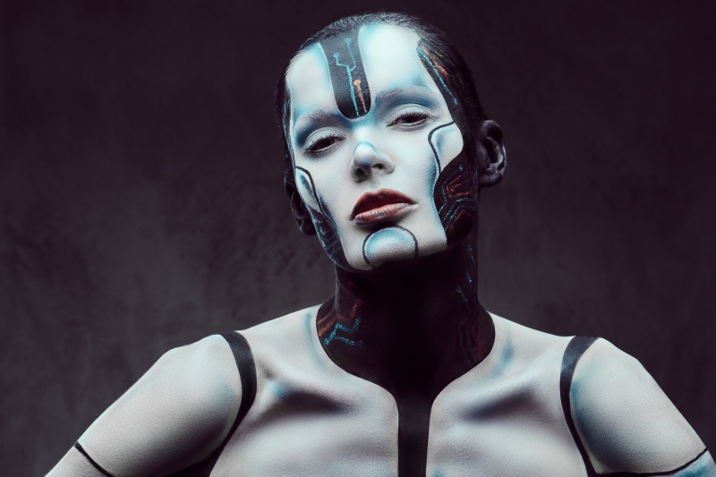 Sensual cyber woman. Technology and future concept. Isolated on a dark textured background.